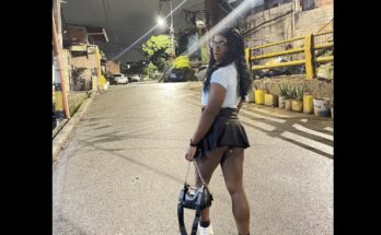 black tranny in short skirt poses in the street at night